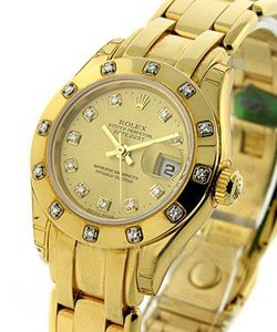 Masterpeice Lady's in Yellow Gold with 12 Diamond Bezel on Yellow Gold Pearlmaster Bracelet with Champagne Diamond Dial
