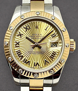 Datejust Lady's in Steel with Yellow Gold 12 Diamond Bezel on Oyster Bracelet with Champagne Sunbeam Roman Dial