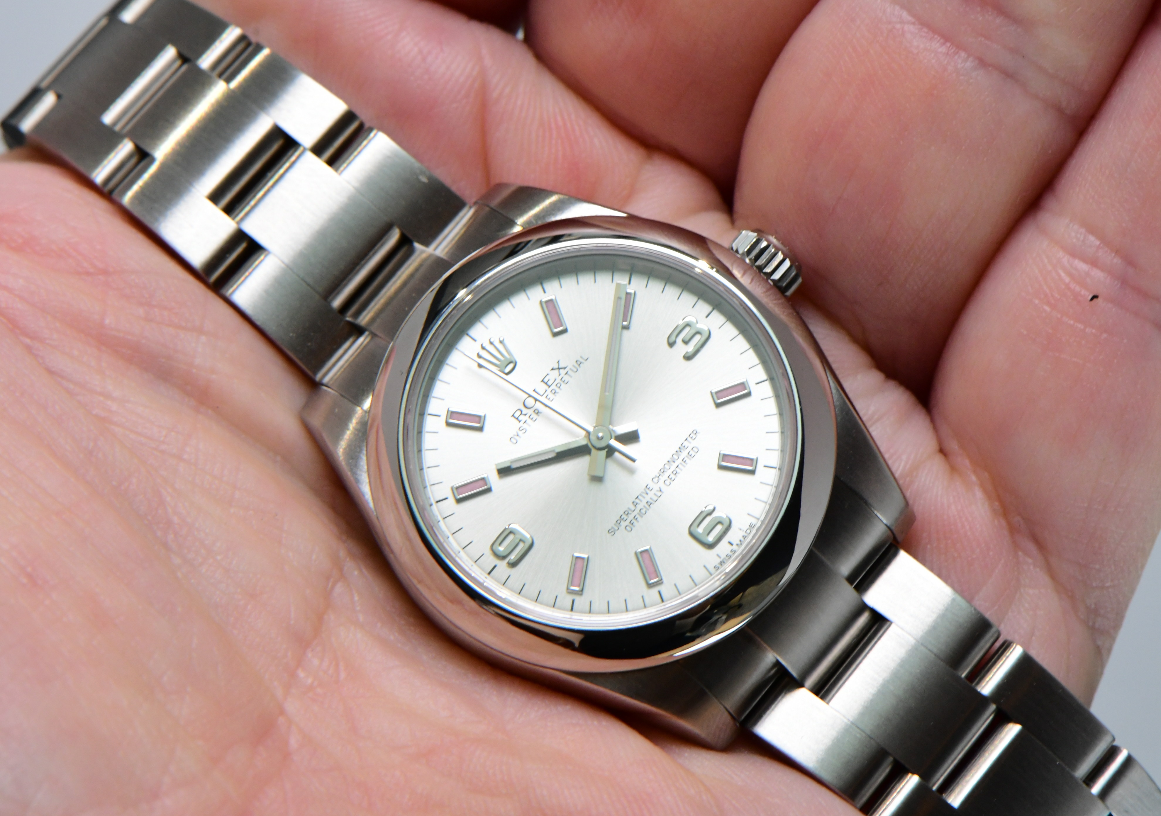 Pre-Owned Rolex Mid Size Oyster Perpetual in Steel with Smooth Bezel on Oyster Bracelet with Silver Arabic and Pink Stick Dial