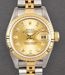 Datejust 26mm in Steel with Yellow Gold Fluted Bezel on Bracelet with Champagne Diamond Dial